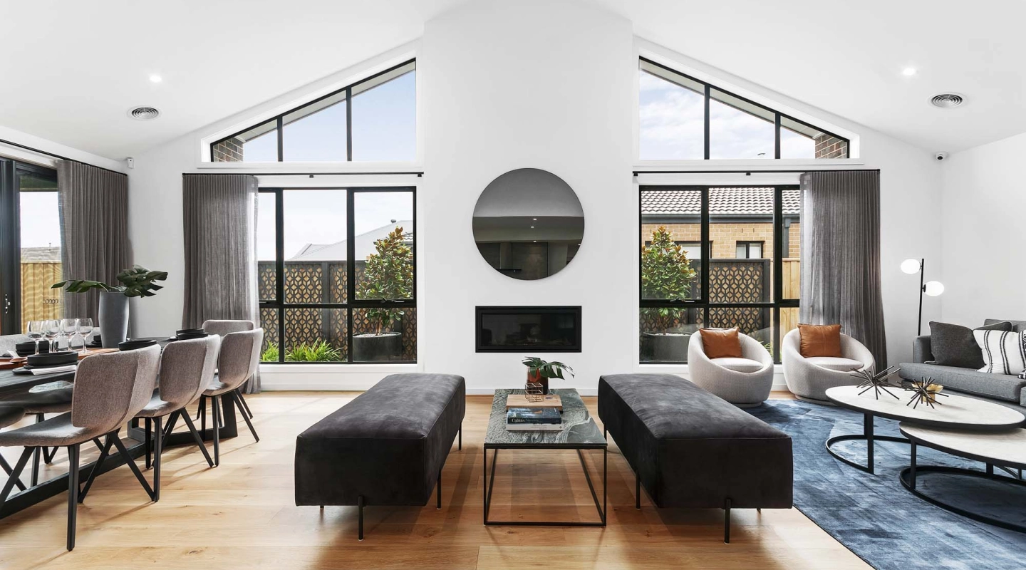 raked ceiling and high windows in your living room with a built-in electric fireplace at tamworth 32