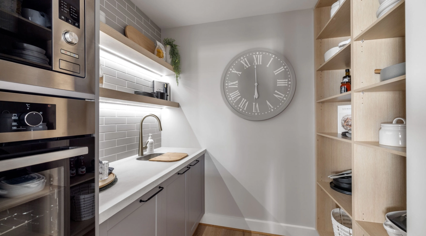 butler's pantry with light grey staggered tiling chrome faucet and timber shelving